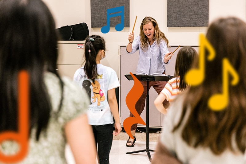A voice teacher leading a choir class