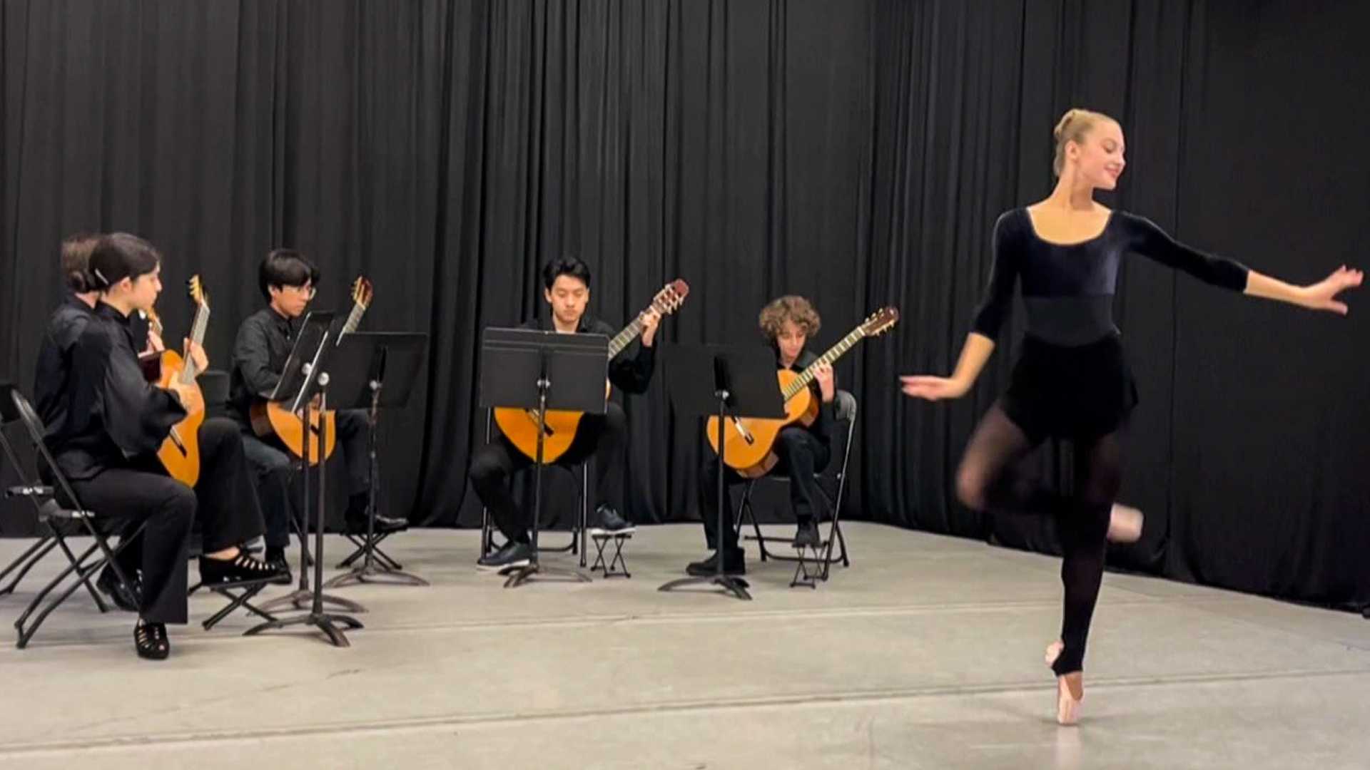 dancevision A dancer performs in front of four guitarists